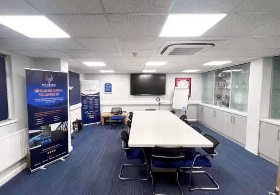 Conference room with central table, ergonomic chairs for professional meetings and events.