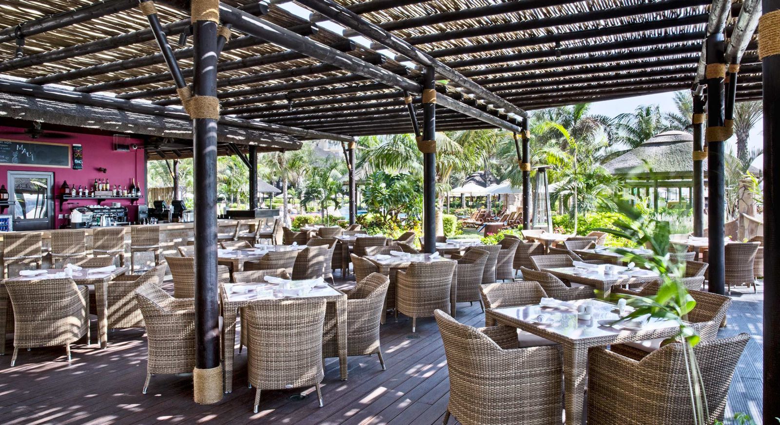 Maui Beach Restaurant outdoor dining area with wicker furniture, ideal for events in Dubai.