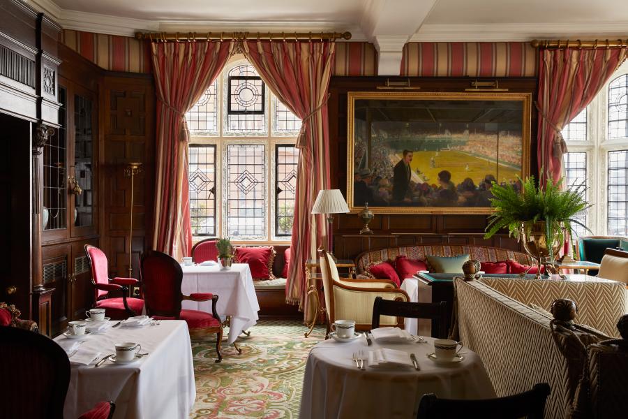 Elegant meeting space in Aspire House with plush seating and stained glass for events.