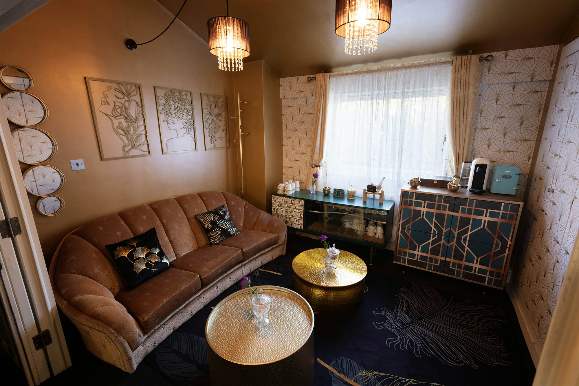 Stylish lounge in Aspire House with plush sofa, ideal for meetings and events.