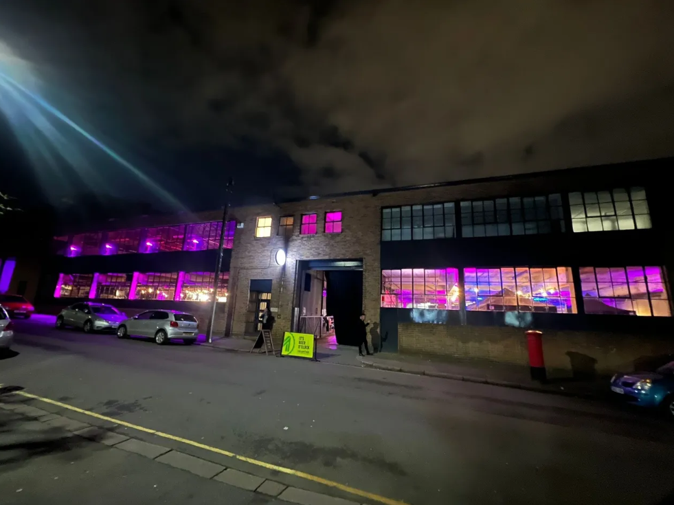 Vibrant event venue with purple lighting, ideal for corporate gatherings and celebrations.