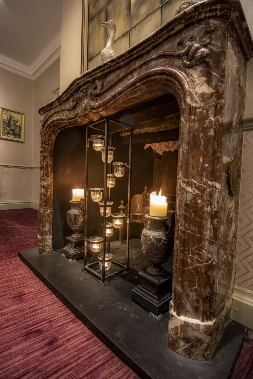 Elegant fireplace in The Lanson Library, perfect for intimate gatherings and networking events.