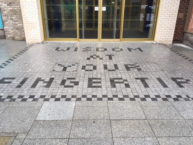 Faraday Room entrance with "Wisdom at Your Fingertip" tiles for events and meetings.