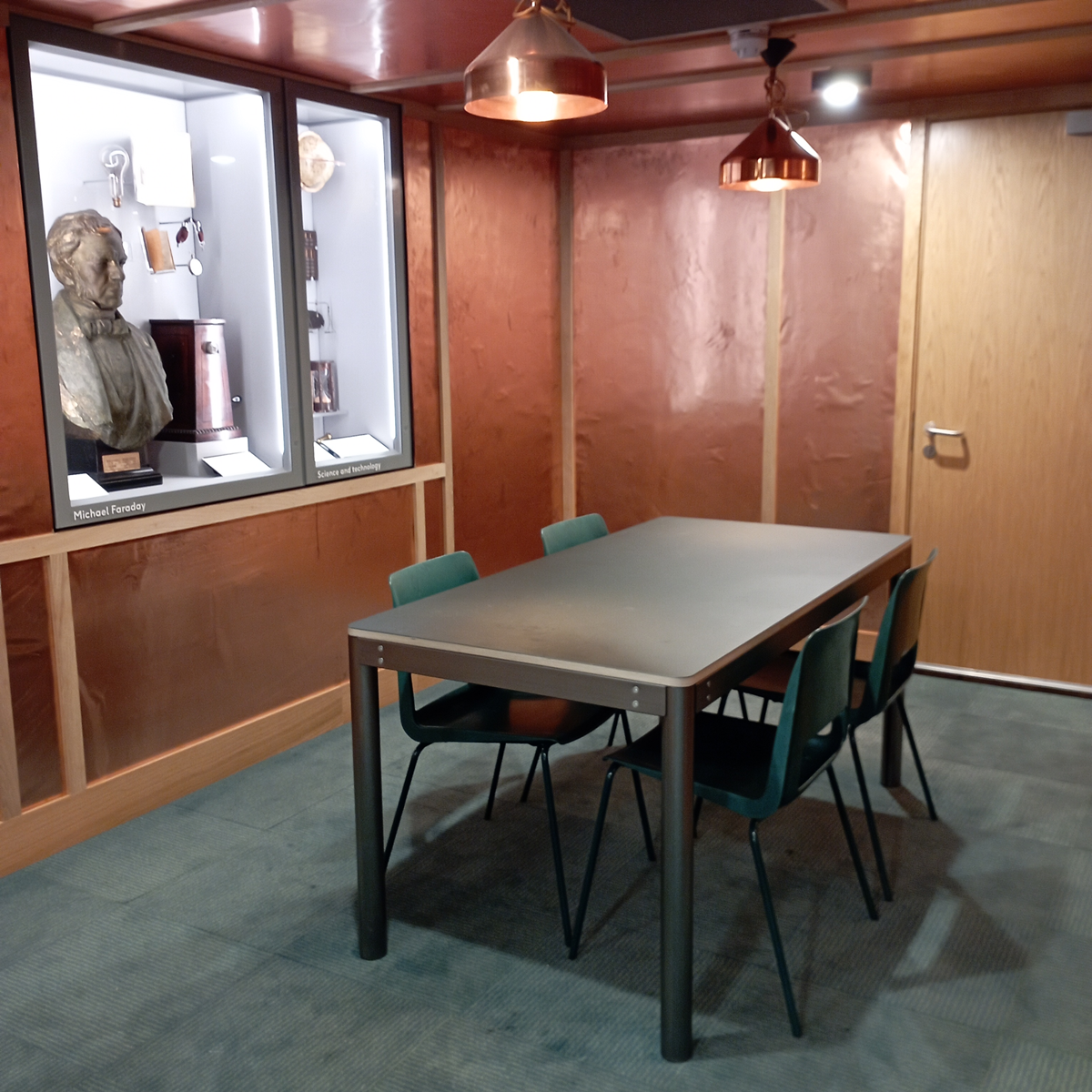 Minimalist meeting space with copper-toned walls for creative discussions in Southwark.