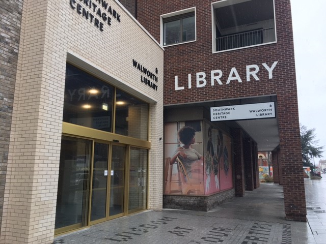 Modern library entrance with glass door at Southwark Heritage Centre for events and workshops.