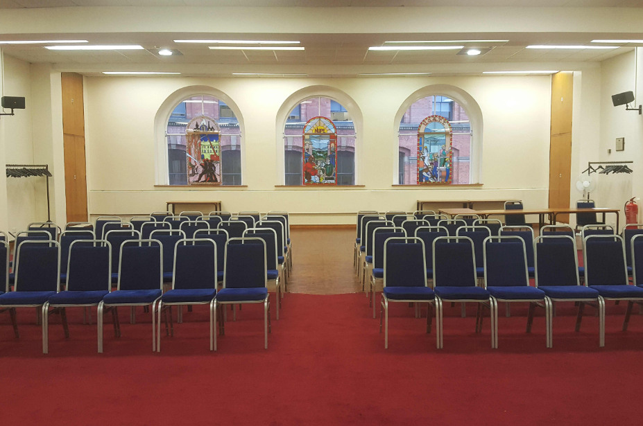 Large Hall at Mechanics Conference Centre with blue chairs for meetings and workshops.