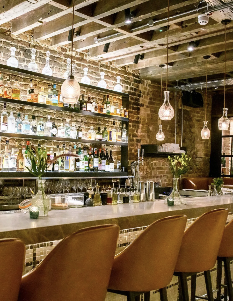 Stylish Sucre Bar with spirits display, perfect for cocktail receptions and networking events.