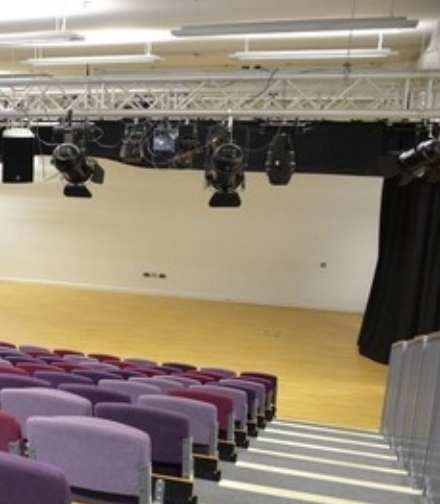 Versatile theatre space at Stockwood Park Academy with professional lighting for events.