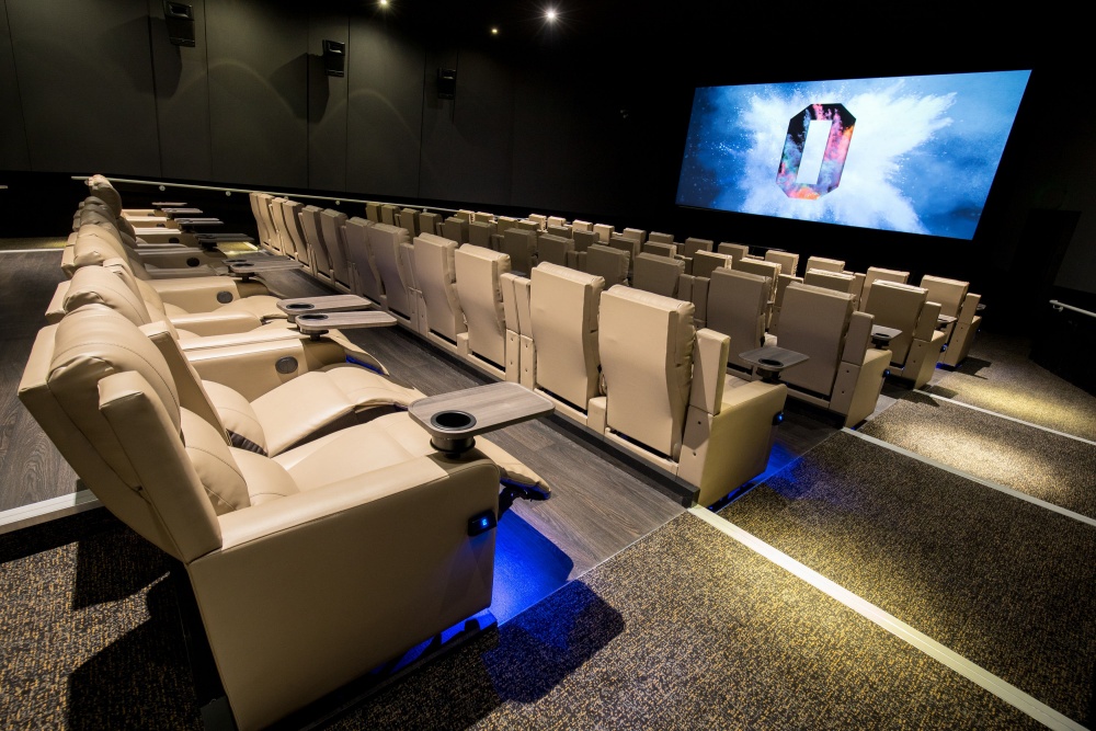 Modern cinema with plush reclining seats for private screenings and corporate events.