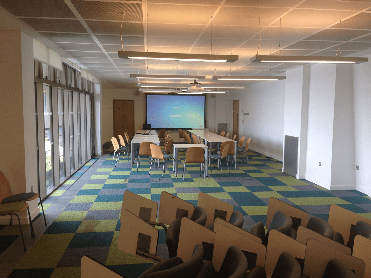 Versatile Meeting Room 3 at Canada Water Library with large screen, ideal for workshops.