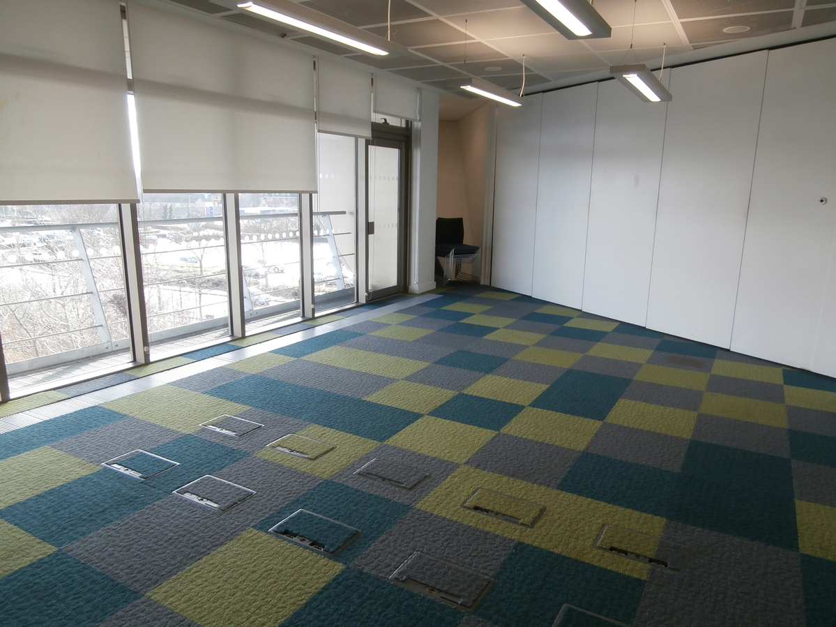 Versatile Meeting Room 5 at Canada Water Library, bright with large windows for events.