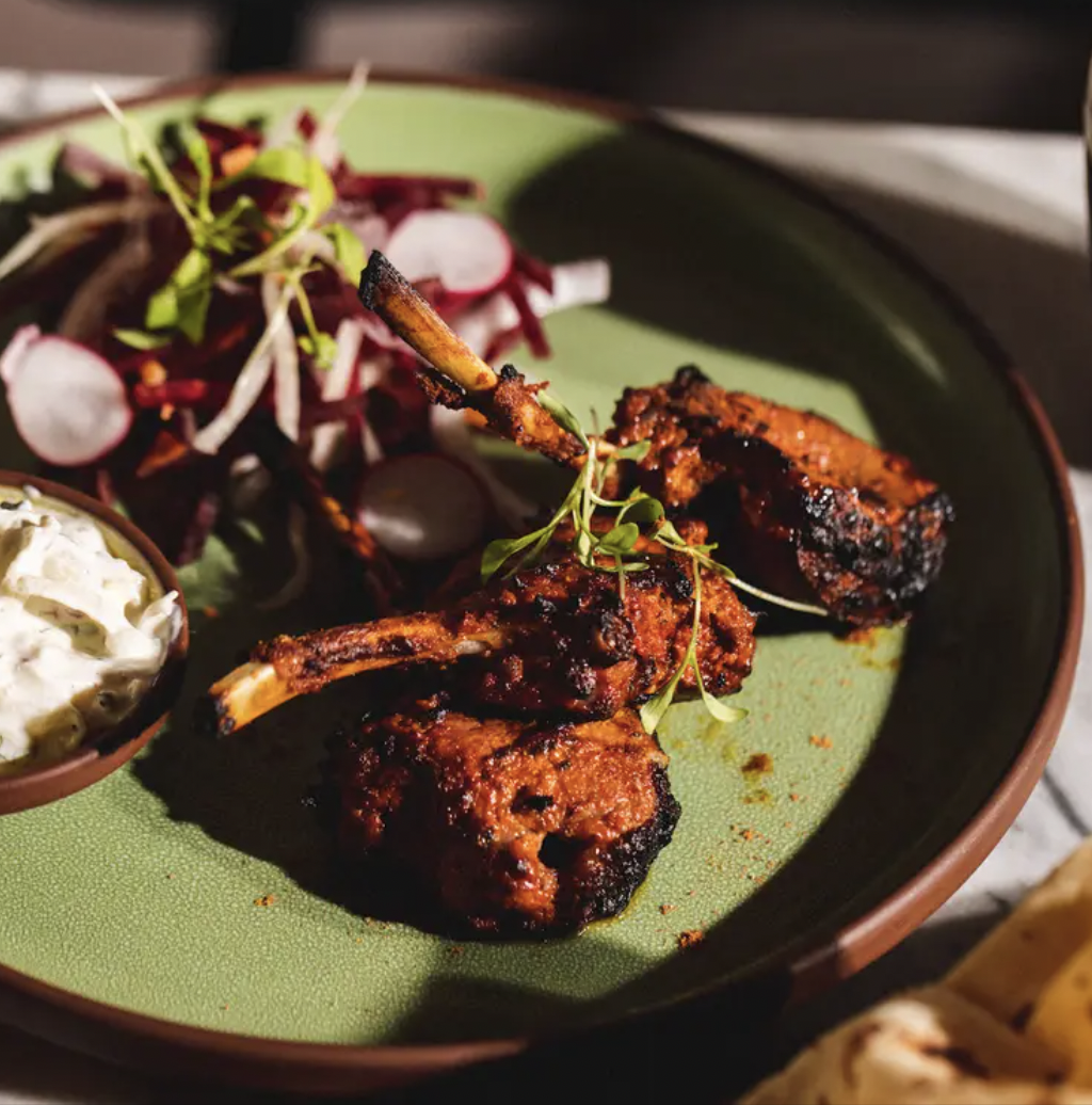 Grilled lamb chops with salad at Biryani Kebab Chai, perfect for upscale events.