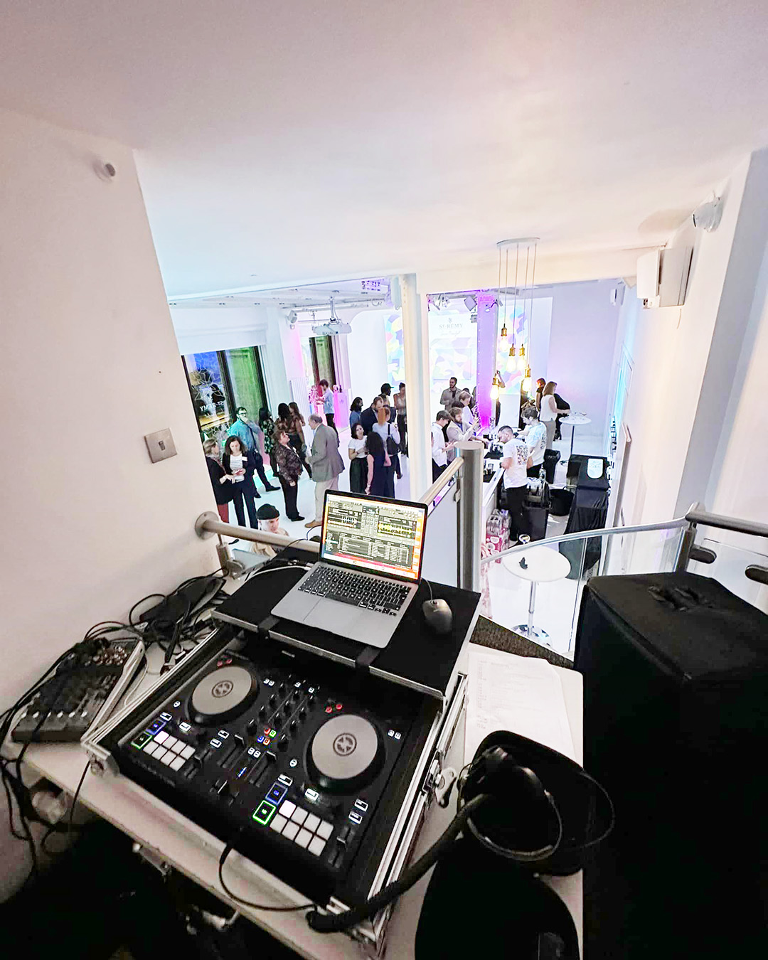 Vibrant Drink Reception at Icetank with DJ setup and colorful lighting for networking.