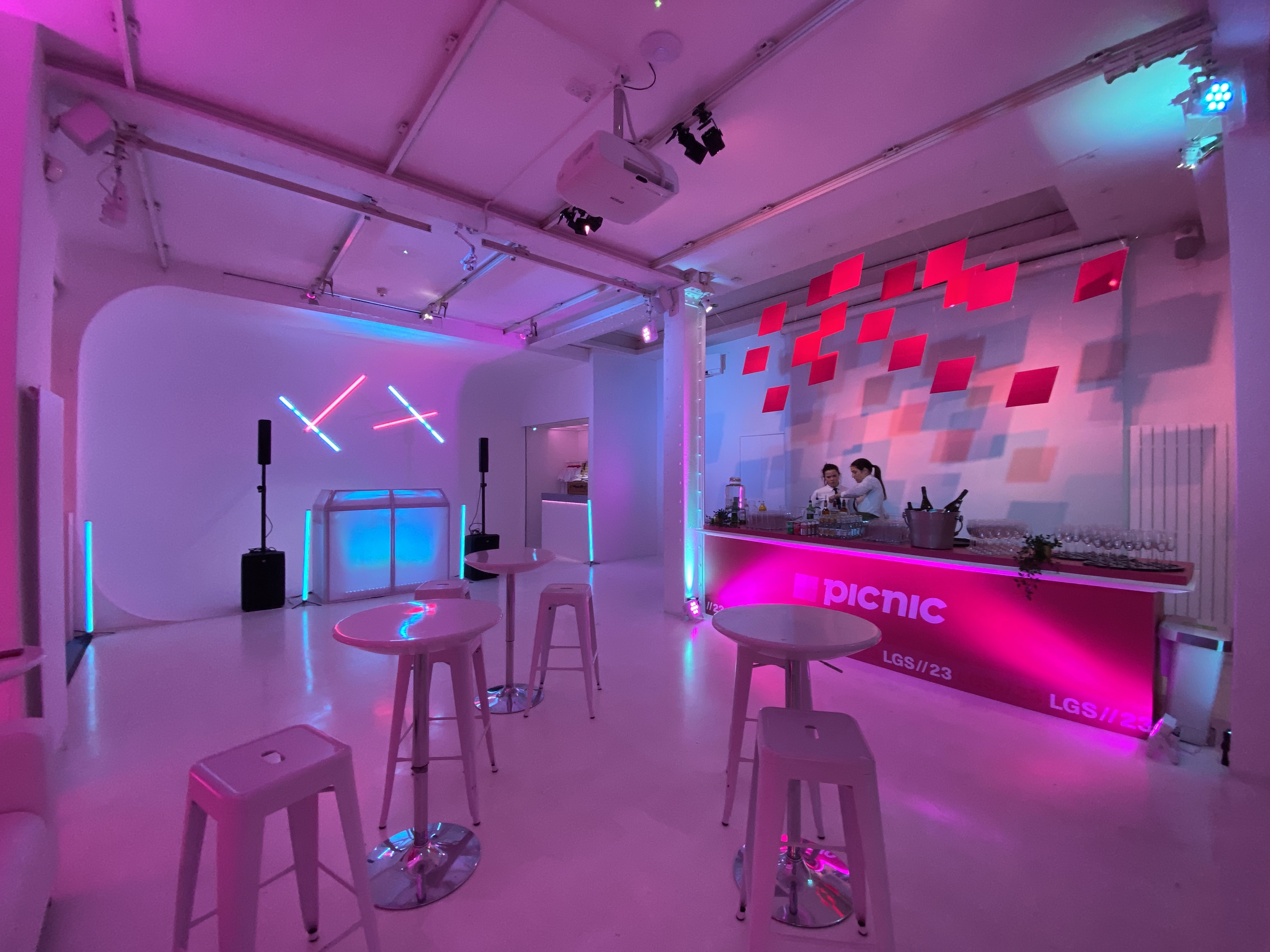 Modern event space with vibrant lighting for stylish drink receptions and social gatherings.