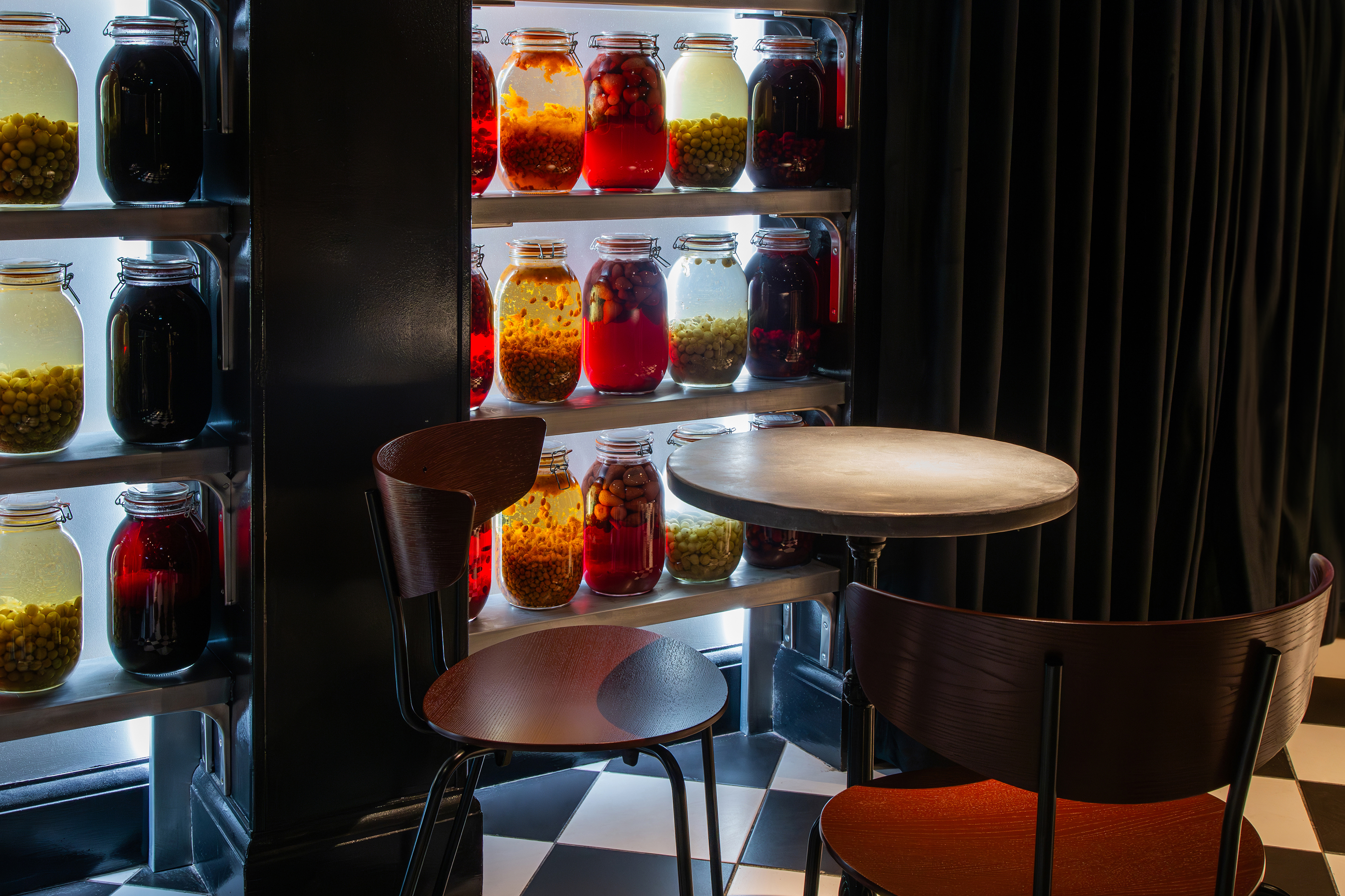 Stylish Bar & Karaoke space with colorful jars, perfect for gatherings and brainstorming.