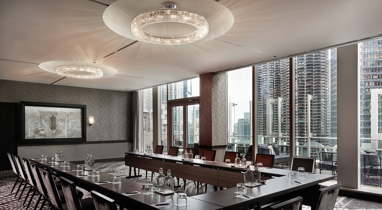 Sophisticated meeting room with conference table and city views at LondonHouse Chicago.