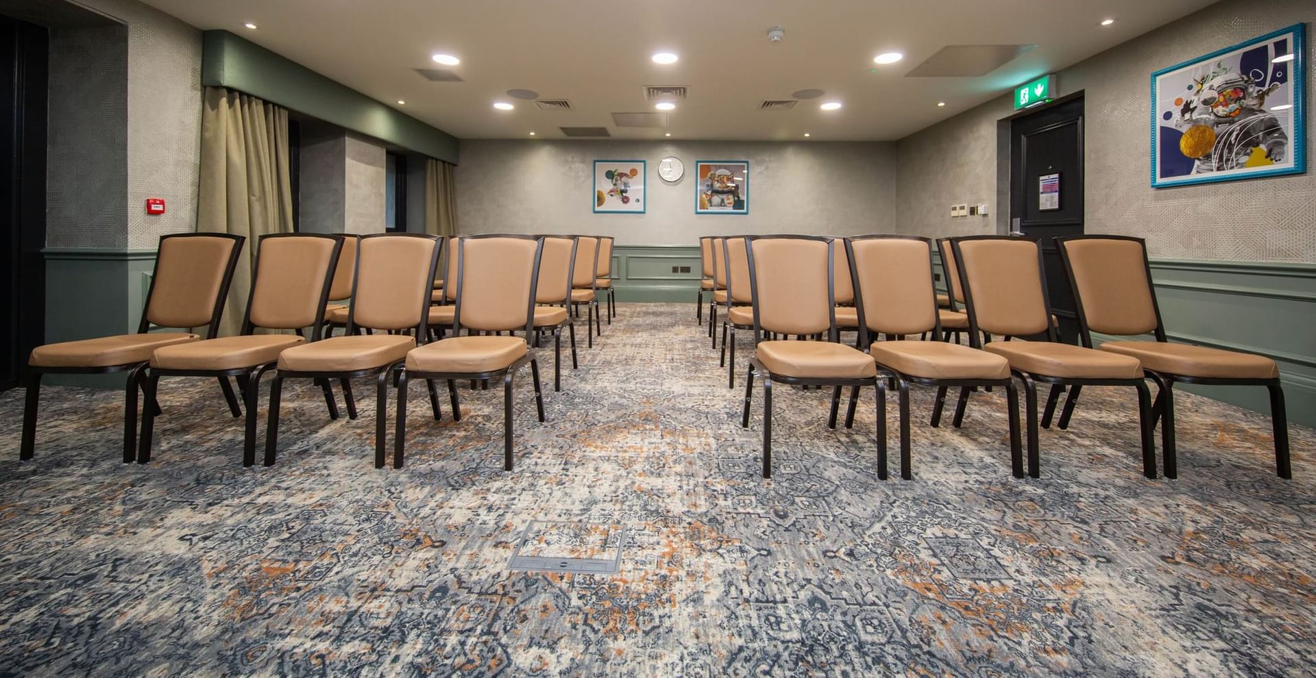 Seacole and Bly meeting room with beige chairs, perfect for presentations and workshops.