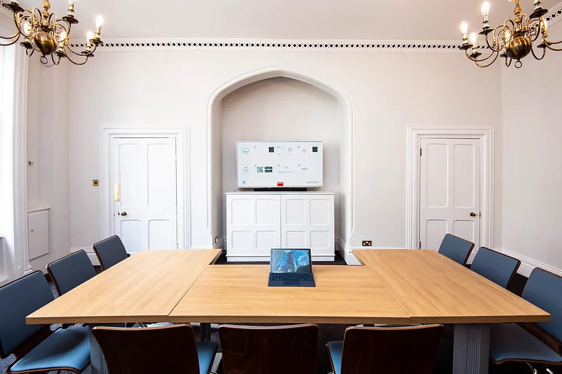 Modern meeting room in Holborn Venues with large wooden table for collaborative events.
