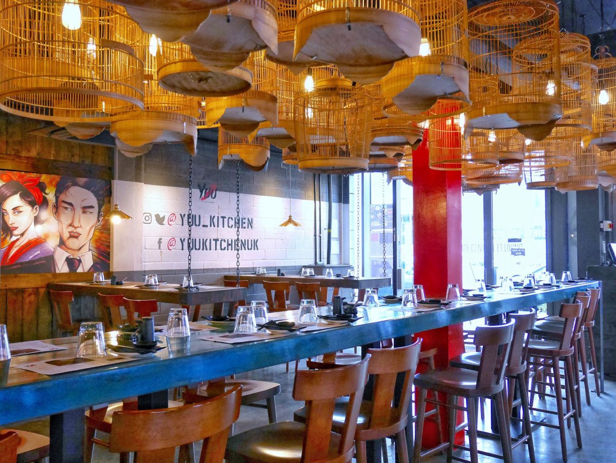 Outdoor terrace at Yuu Kitchen with communal table, perfect for events and gatherings.