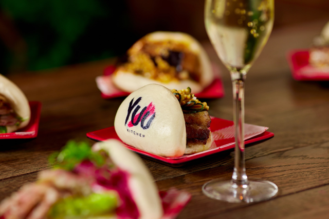 Gourmet bao buns and sparkling wine at Yuu Kitchen for upscale events.