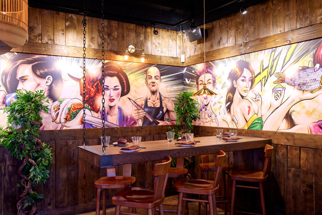 Vibrant Yuu Kitchen restaurant with bold mural, ideal for casual events and meetings.