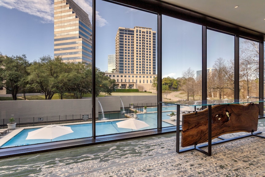 Modern event space at Omni Houston Hotel with large windows and city skyline view.