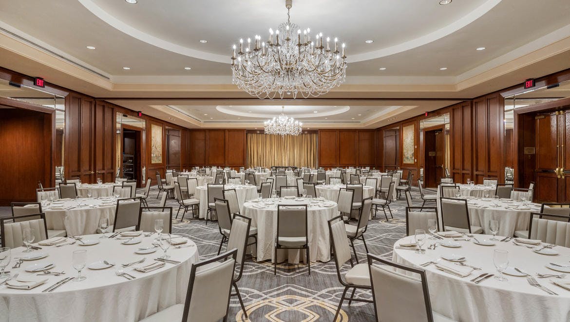 Elegant banquet hall at Omni Houston Hotel with round tables for corporate events.