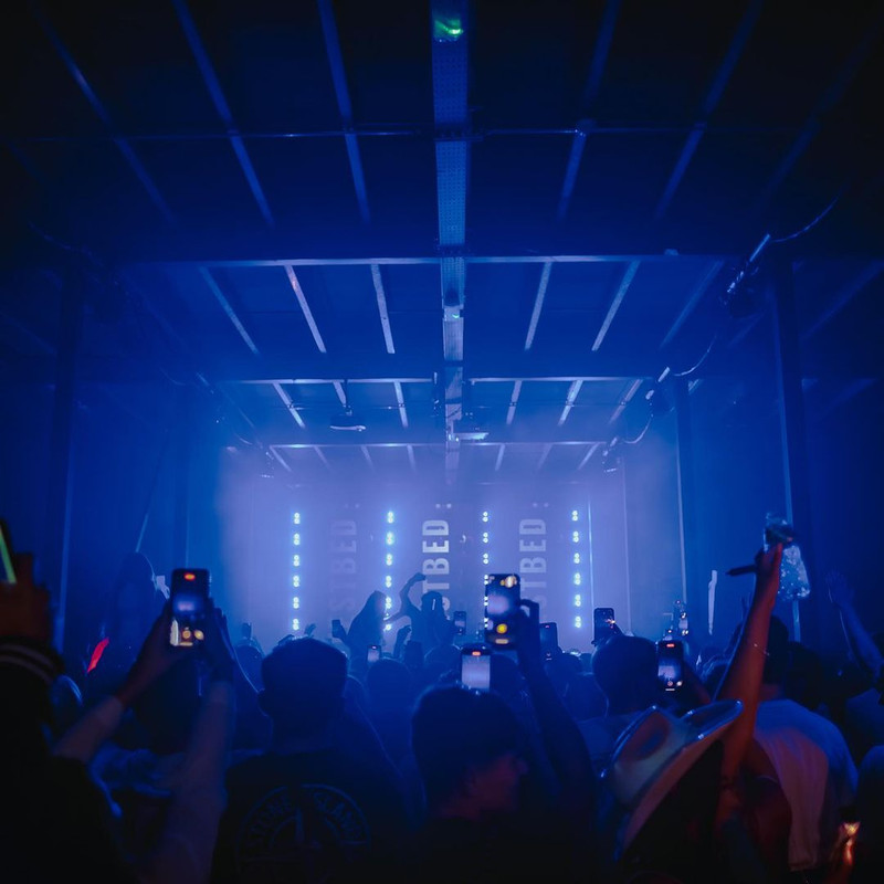 Vibrant live music venue with engaged audience and dynamic stage lights in TESTBED.