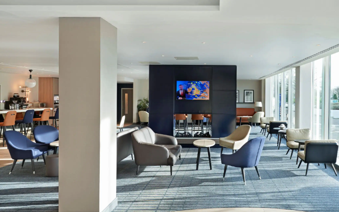 Modern lounge at Hyatt Place London Heathrow, ideal for networking and meetings.