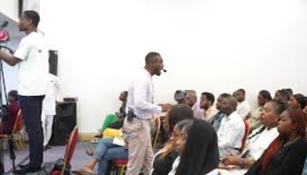 Dynamic conference at Redeemed Pillar of Fire Ministry, engaging speaker with microphone.