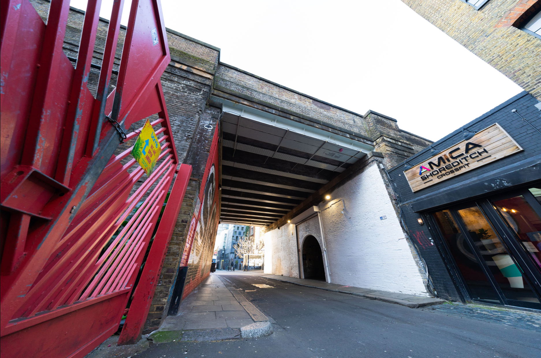 Urban venue entrance with archway, ideal for events and gatherings at 83 Rivington Street.