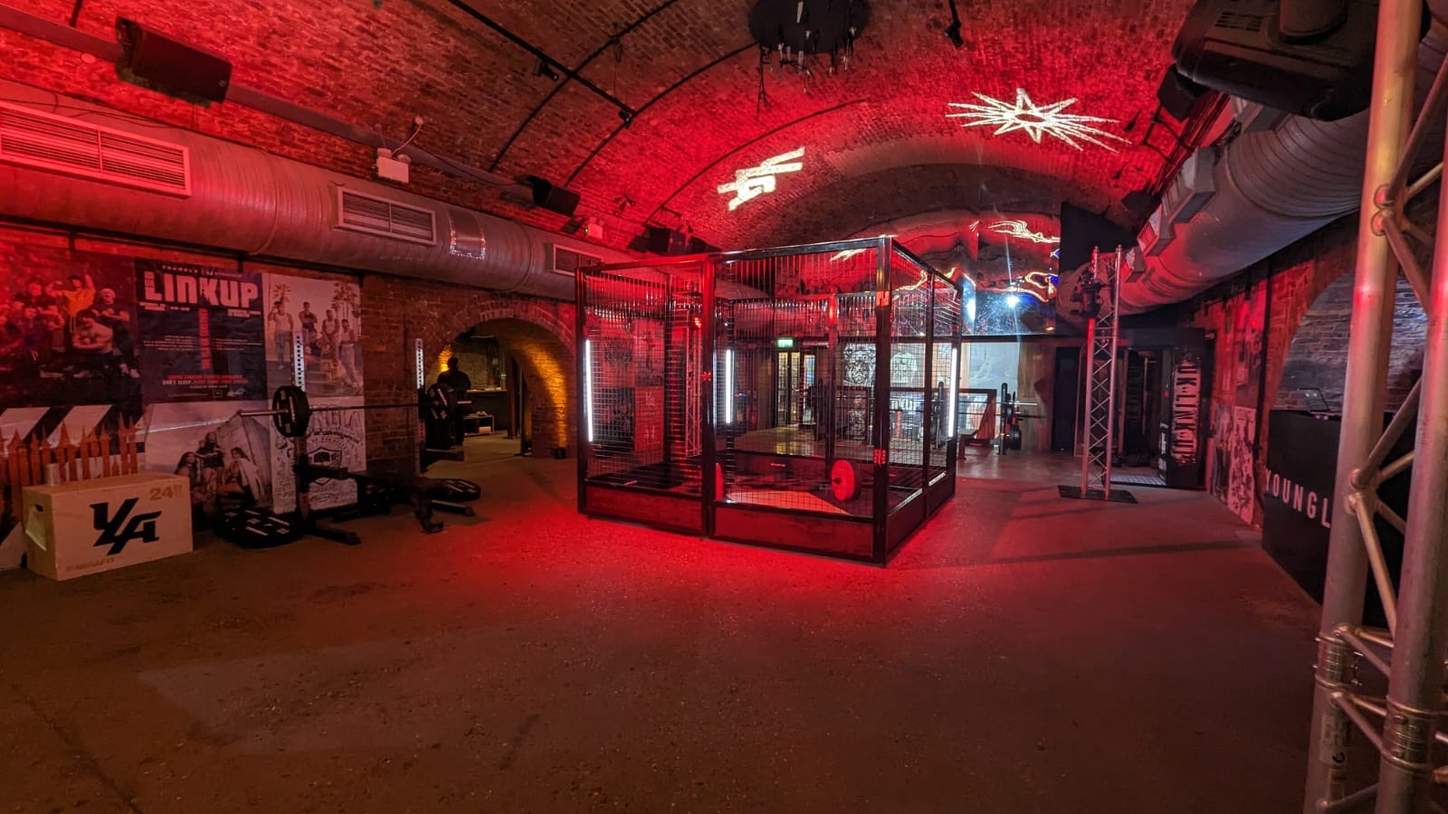 Industrial event space with exposed brick and red lighting for product launches.