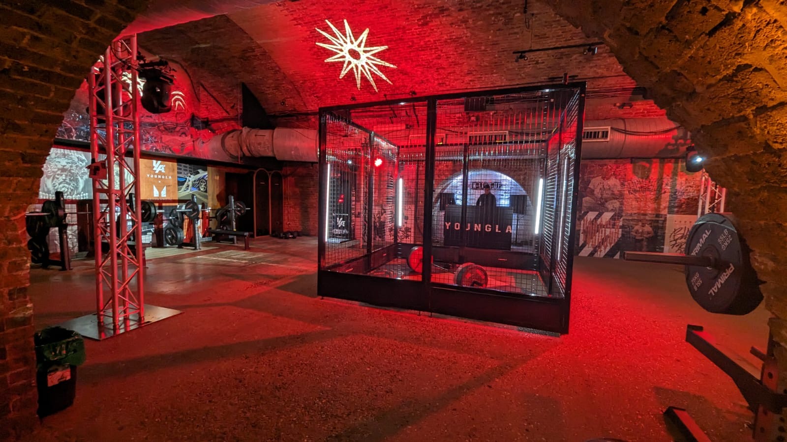 Unique event space with exposed brick and red lighting for team-building and wellness retreats.