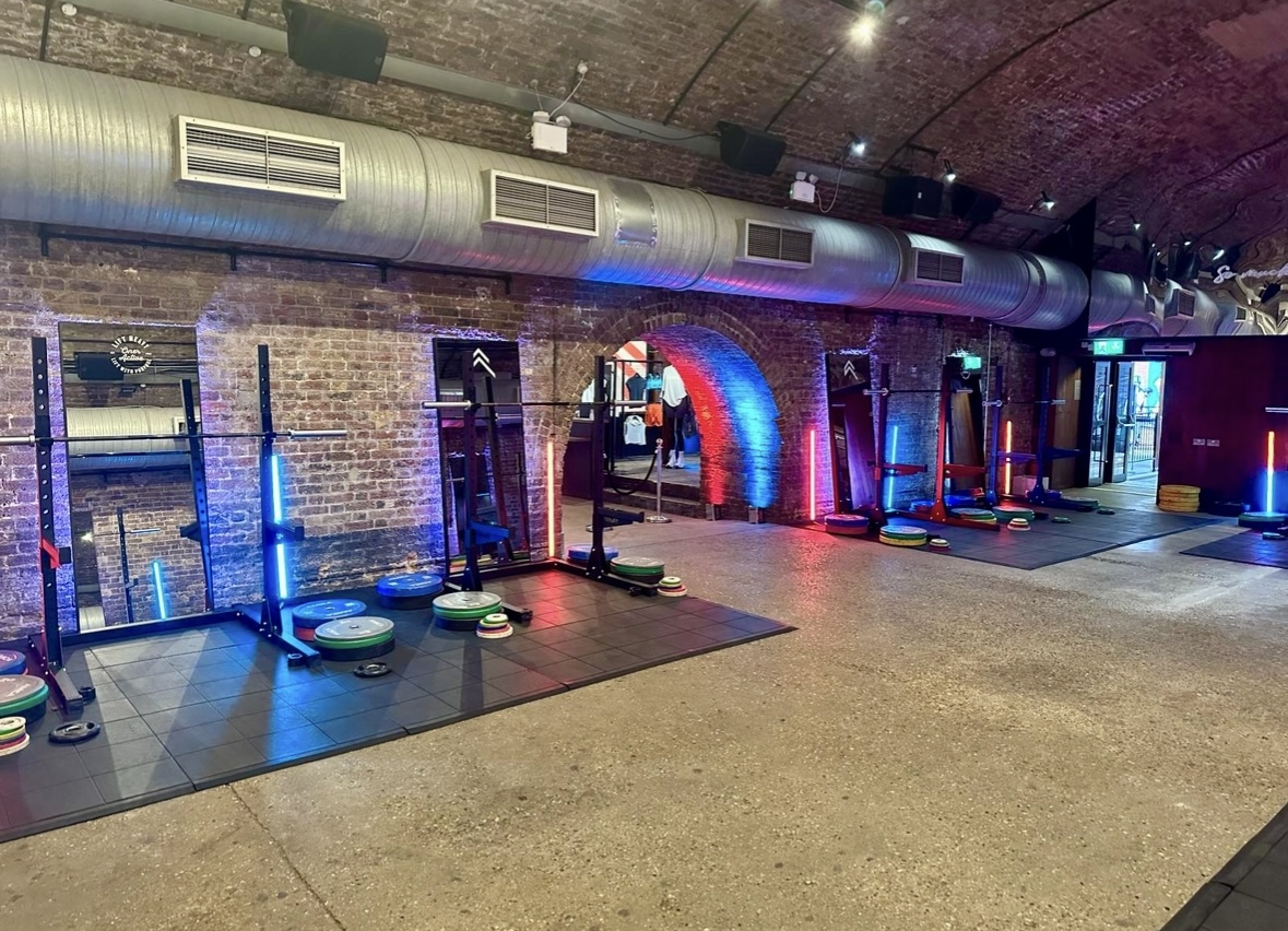 Unique fitness event space with weightlifting equipment and vibrant lighting at 83 Rivington Street.