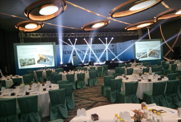 Peacock ballroom conference setup with round tables, ideal for networking events.