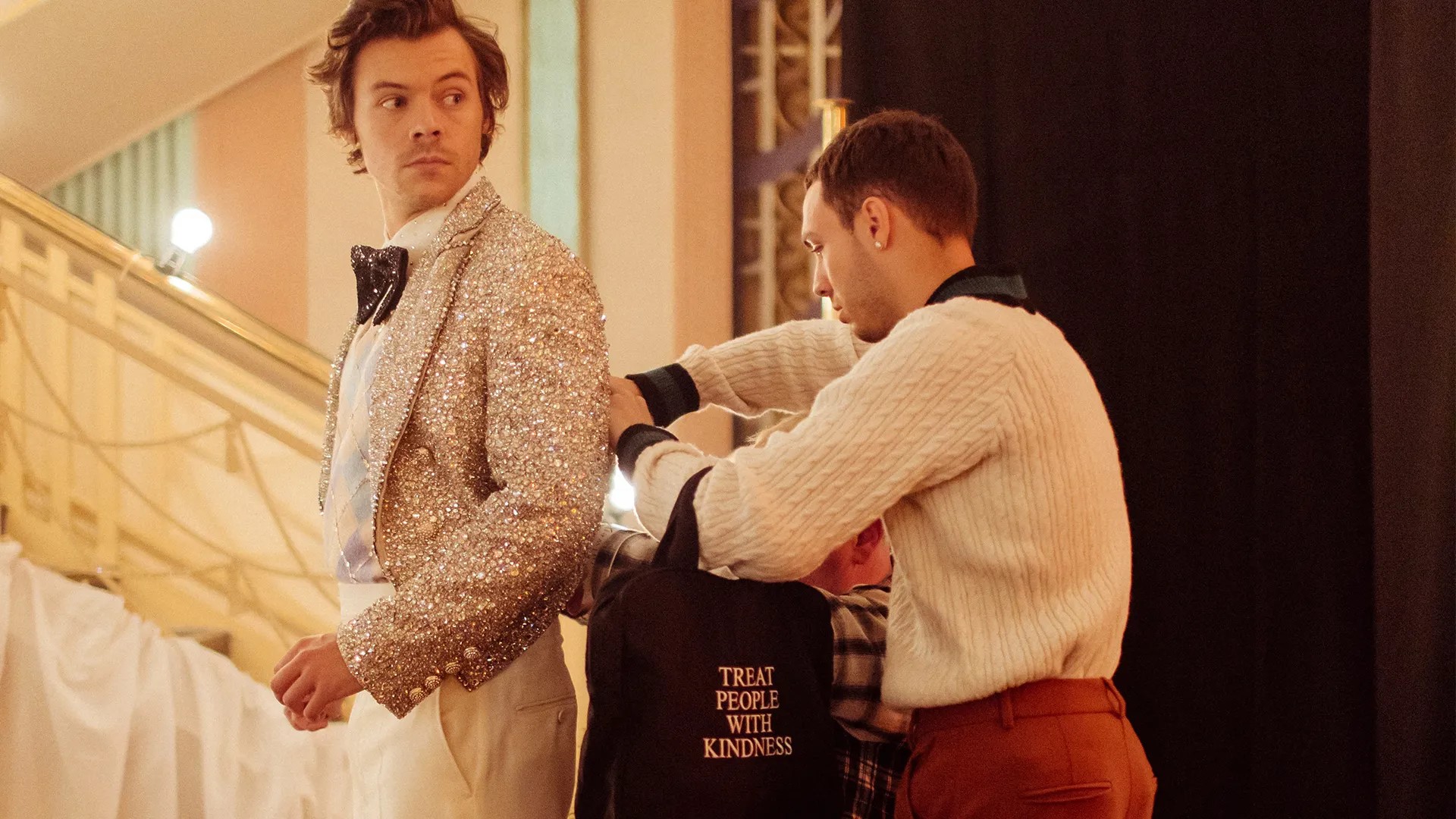 "Troxy Grand Hall event prep: wardrobe adjustments showcase teamwork and glamour."