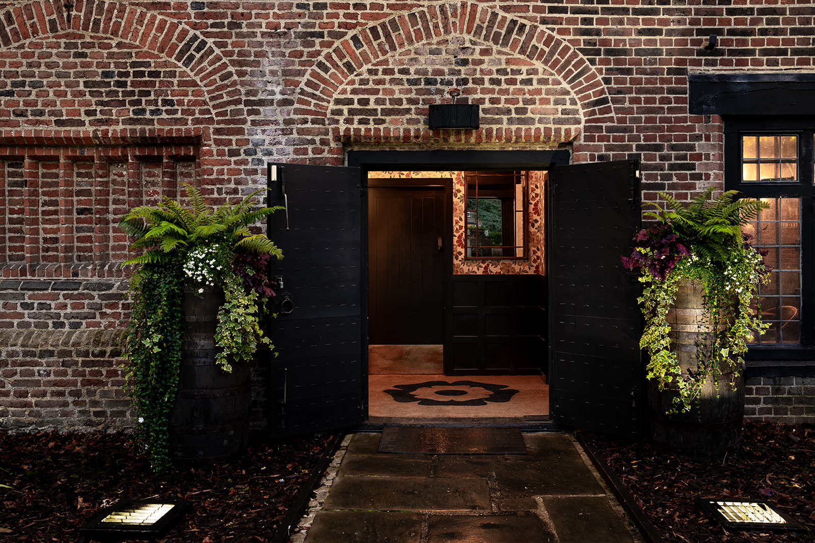 Tudor Barn Eltham entrance with rustic brick facade, ideal for events and gatherings.