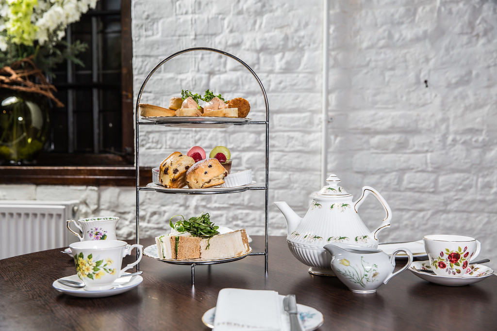 Elegant afternoon tea setup at Moat Terrace, Tudor Barn Eltham for events and gatherings.