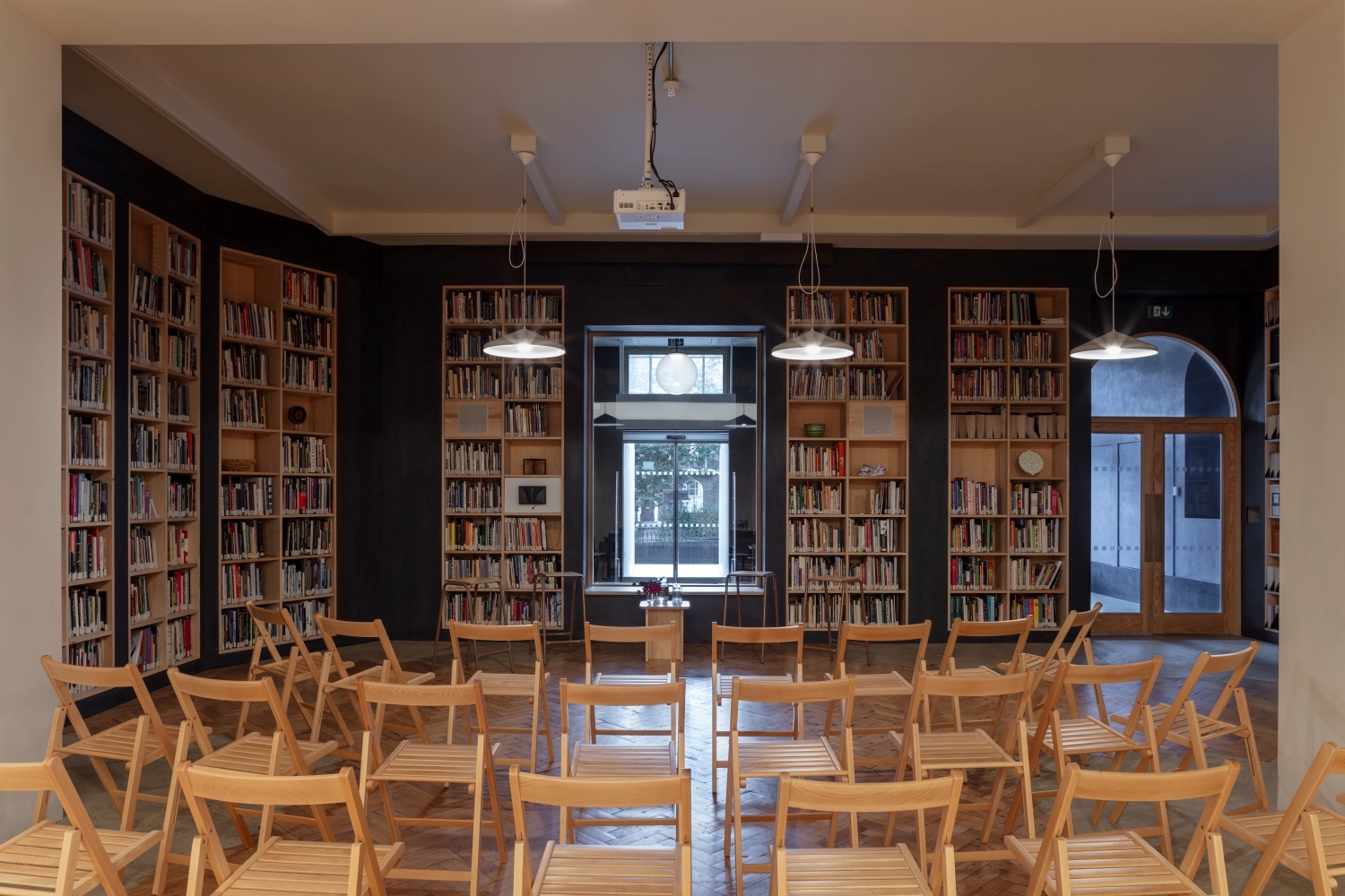 Crafts Council Gallery meeting space with wooden chairs, ideal for workshops and presentations.