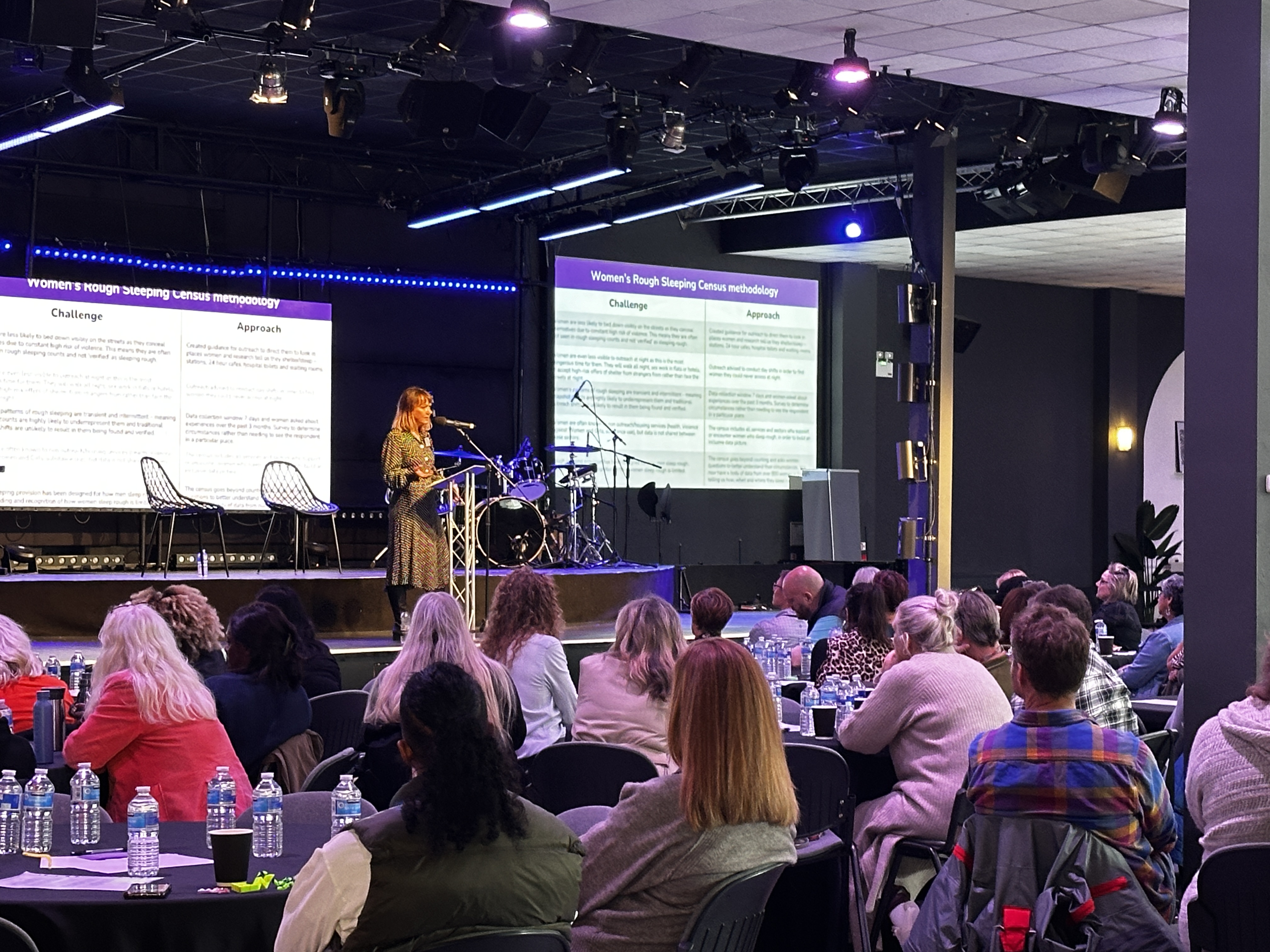 Auditorium event space with speaker engaging audience, ideal for conferences and meetings.