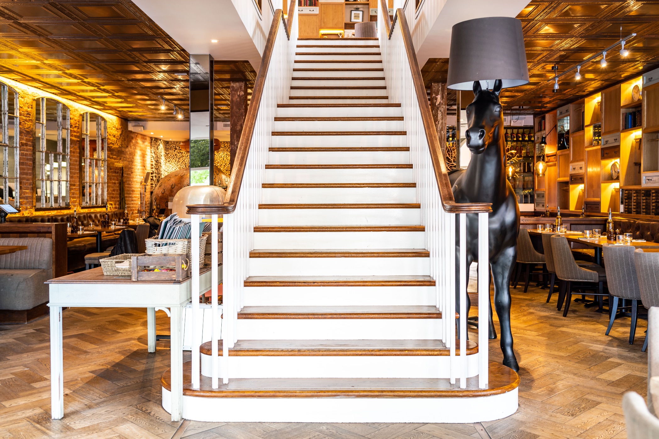 Stylish Wildwood Newmarket restaurant with elegant staircase, ideal for events and gatherings.