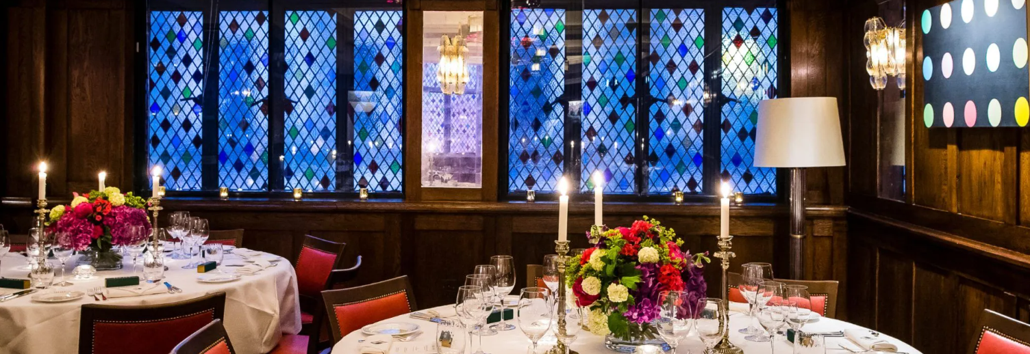 Elegant dining table with floral centerpiece in The IVY West Street for upscale events.