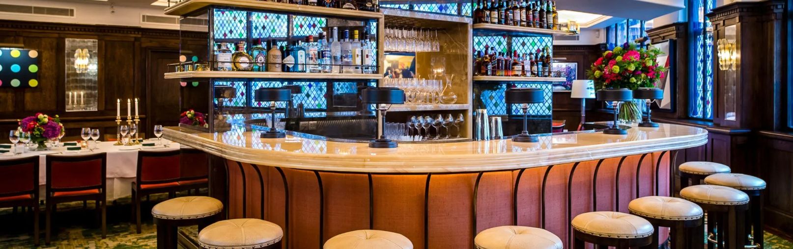 Elegant bar area with curved countertop in The IVY West Street for networking events.