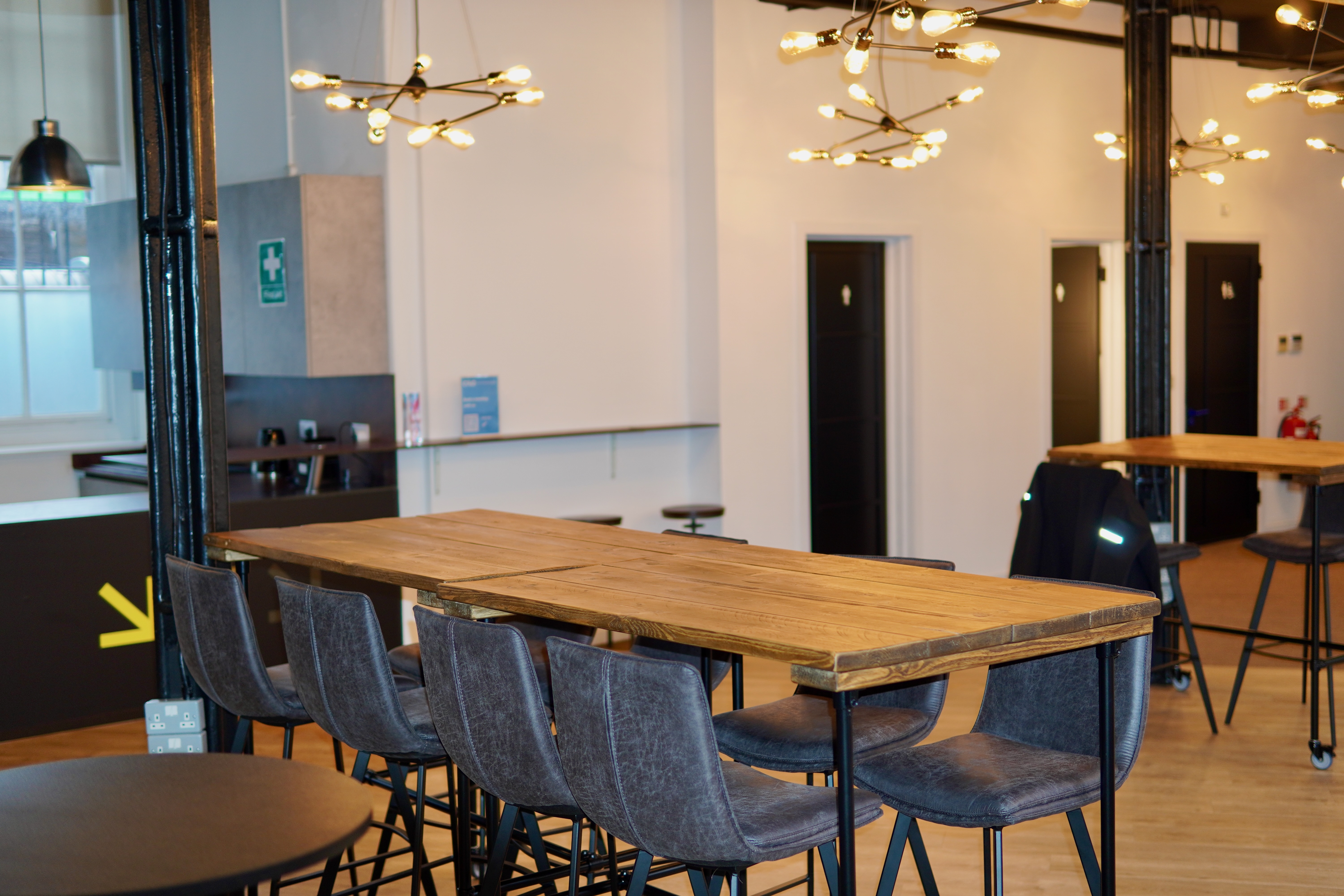 Modern event space at Civo Tech Junction with stylish communal table for networking.