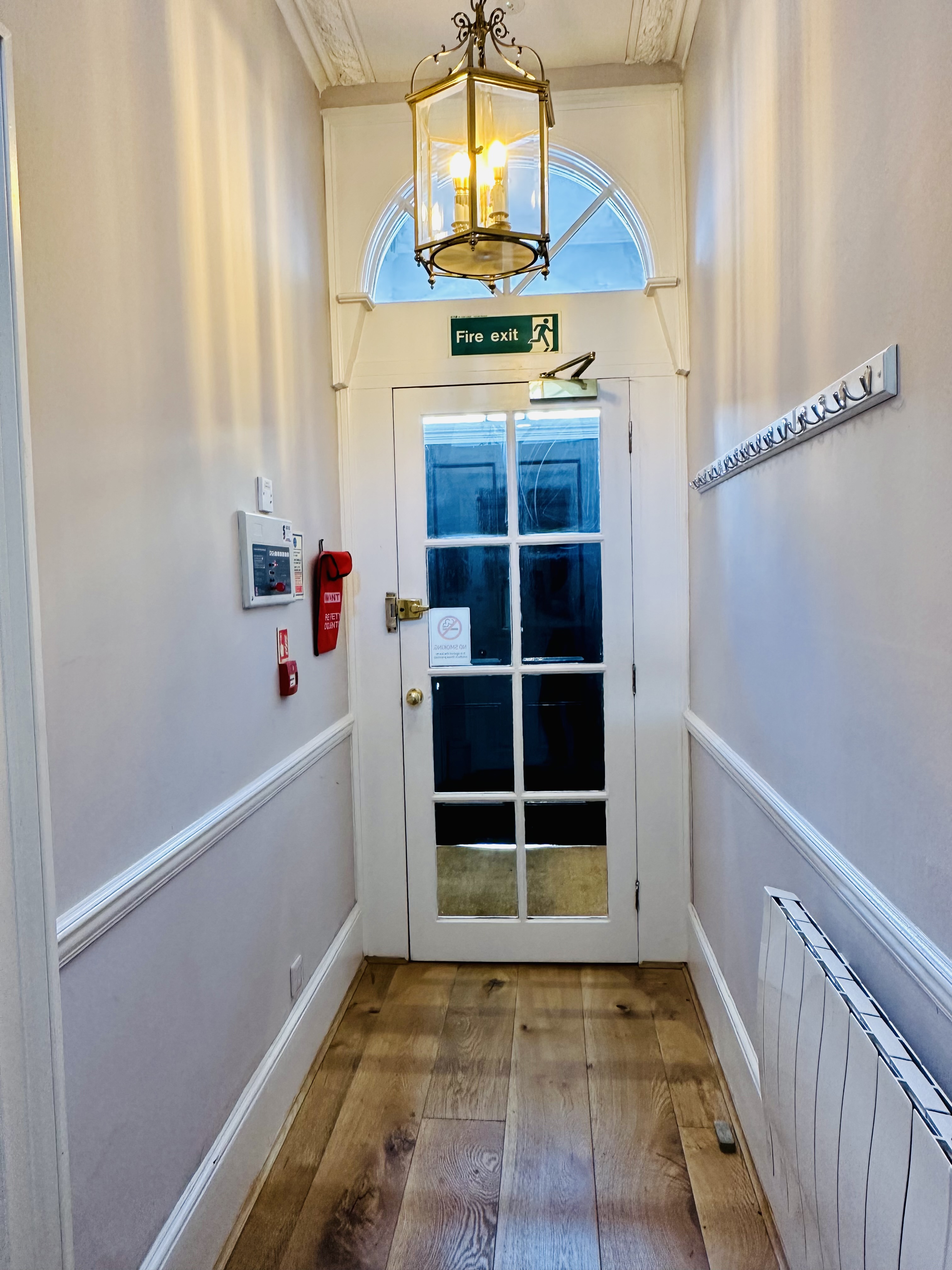 Clean corridor with glass door in reZen studio for professional meetings and events.