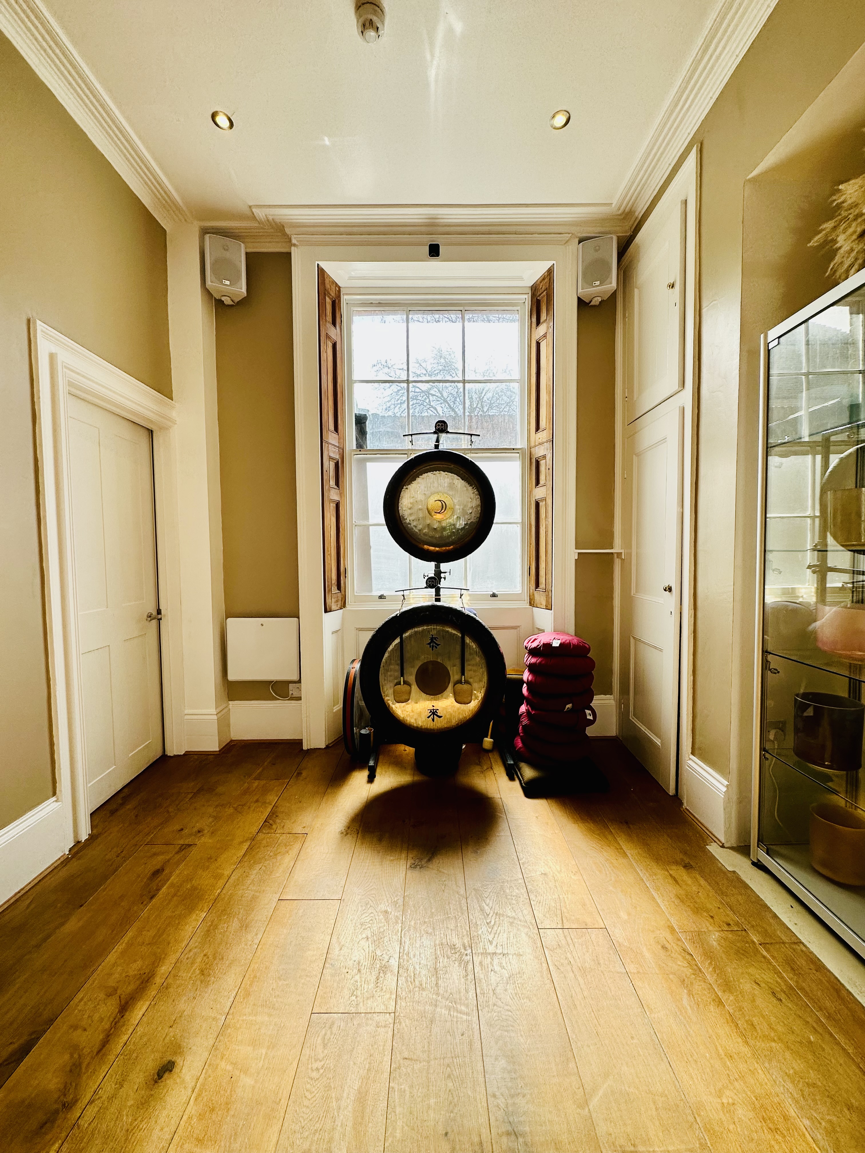 "Serene studio corner with large gong, perfect for wellness retreats and mindfulness workshops."