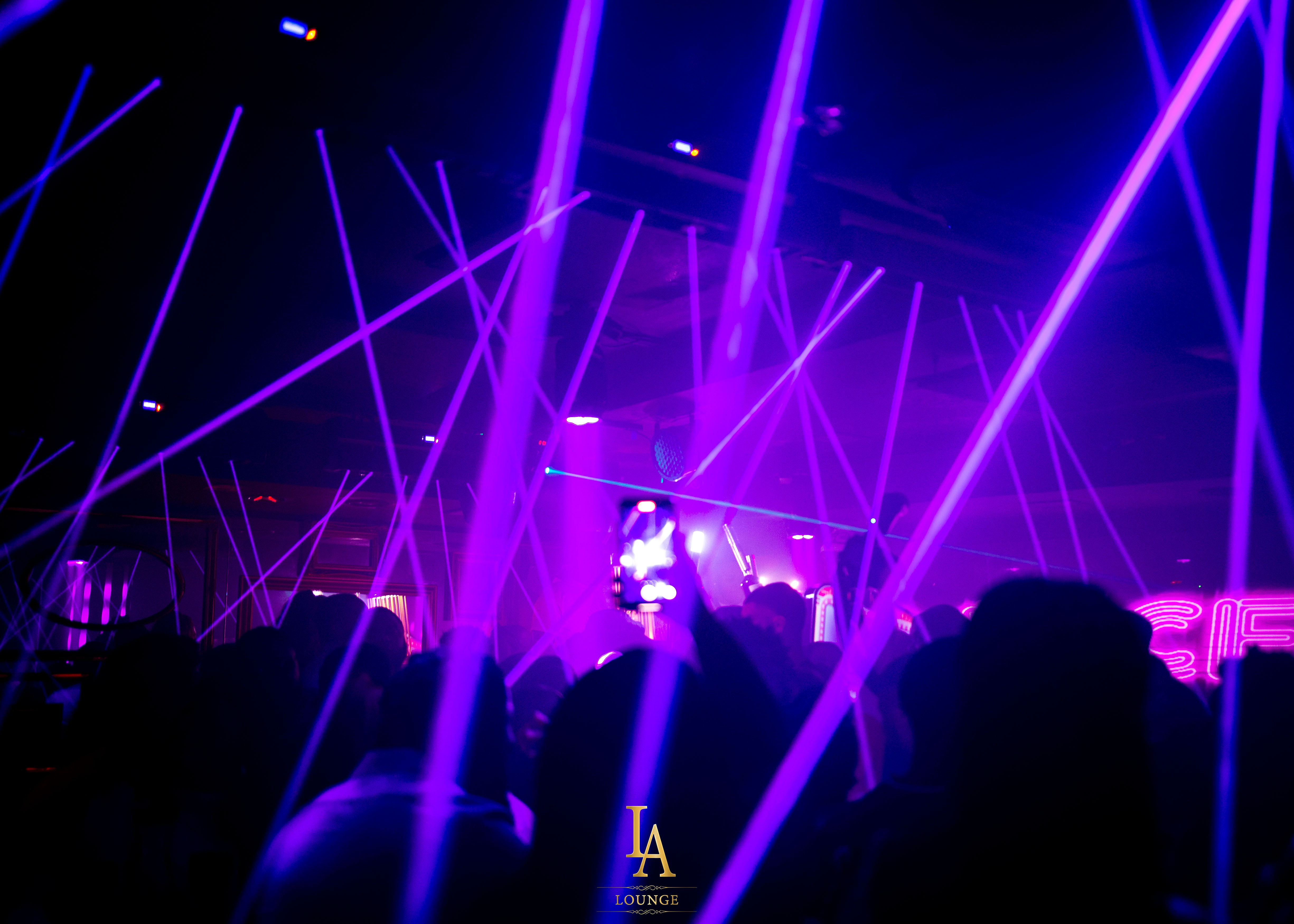 Vibrant LA Lounge nightlife with purple laser lights for corporate parties or celebrations.