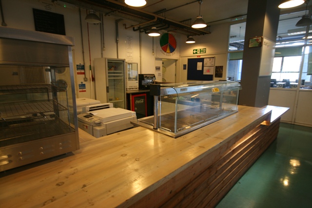 Cafe and Servery at The Harrow Club, featuring a wooden counter for event refreshments.