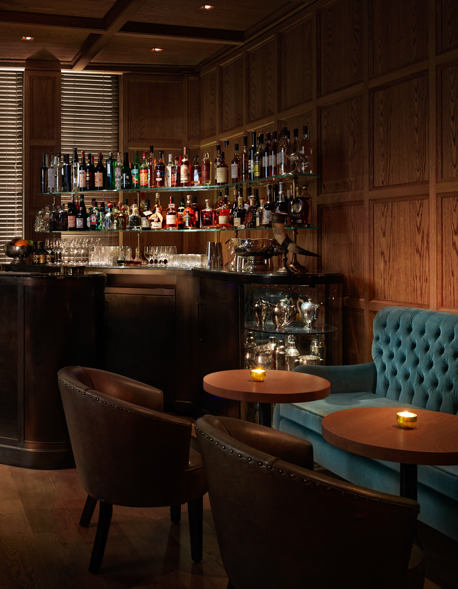 Punch Room bar at The London EDITION, warm wood decor for networking events.