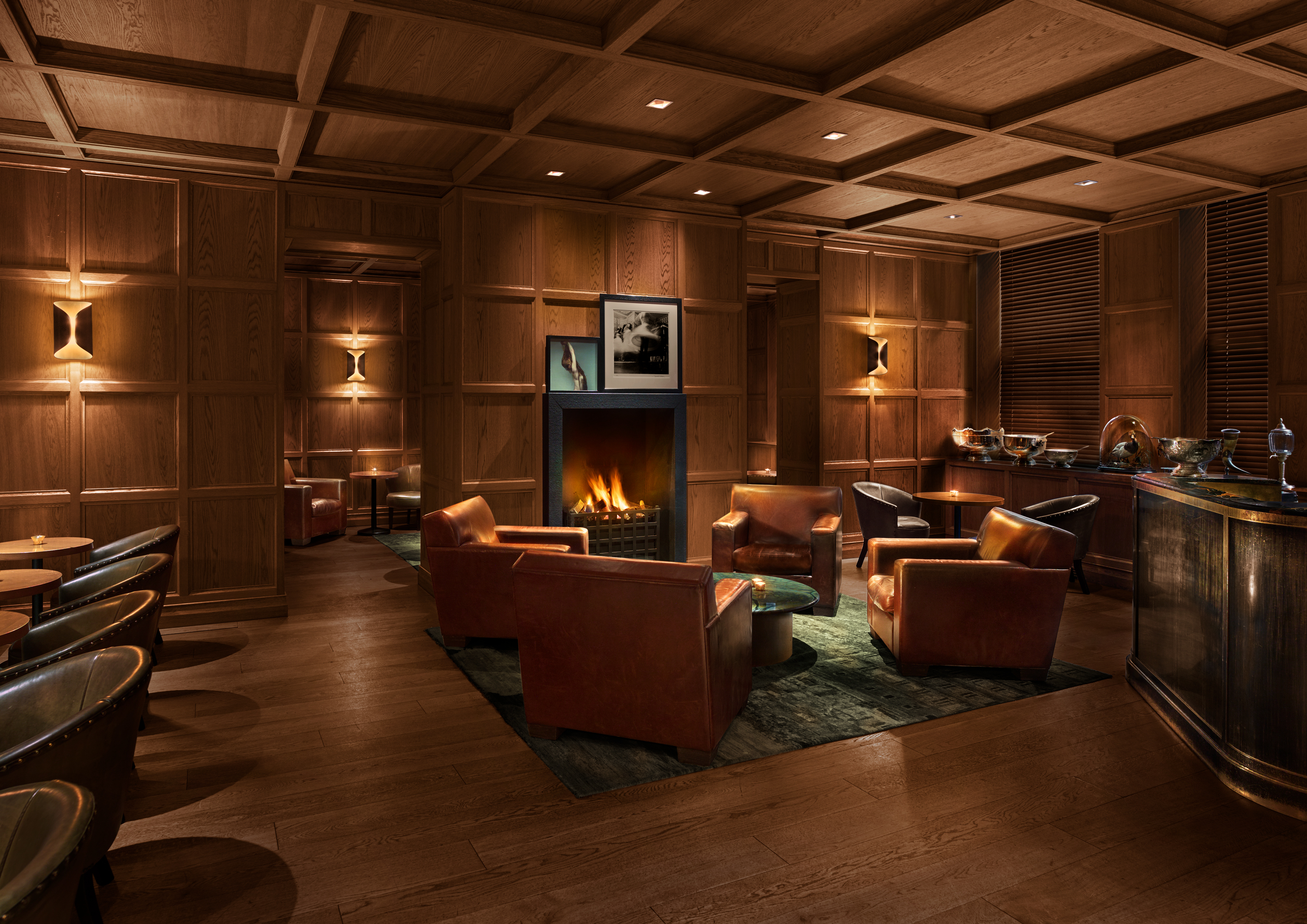 Punch Room at The London EDITION: cozy lounge with warm wood paneling for events.